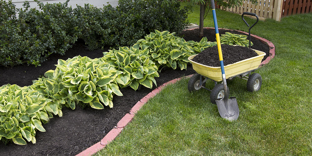 Wallace's Garden Center-Mulch vs. Rock When and How to Use Each One -wheelbarrow of mulch for garden